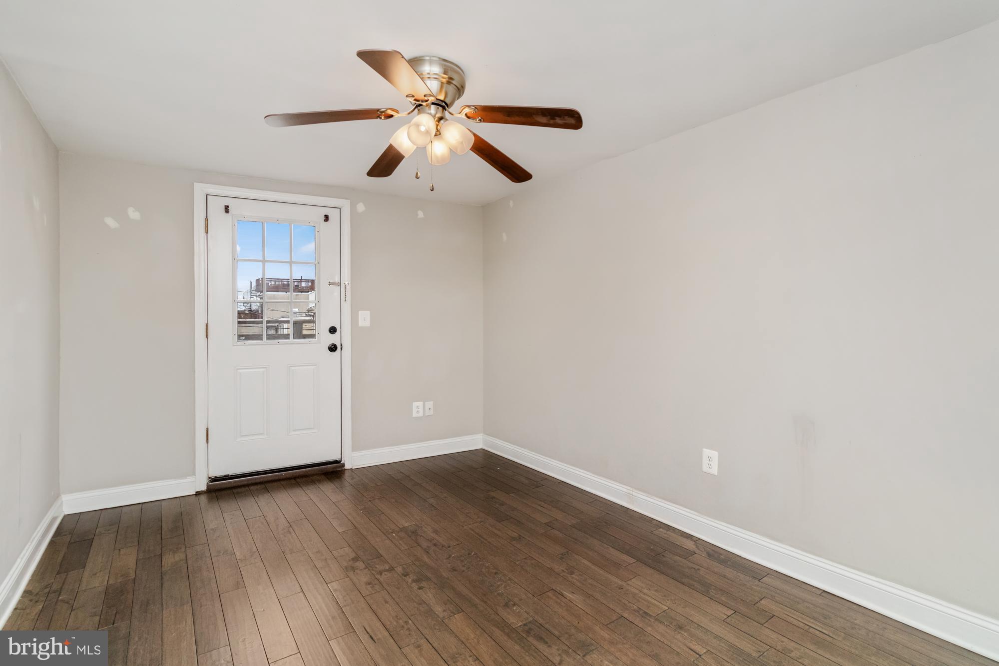 1812 Light Street Baltimore, MD 21230 - Photo 27 of 45 an empty room with wooden floor chandelier fan and windows
