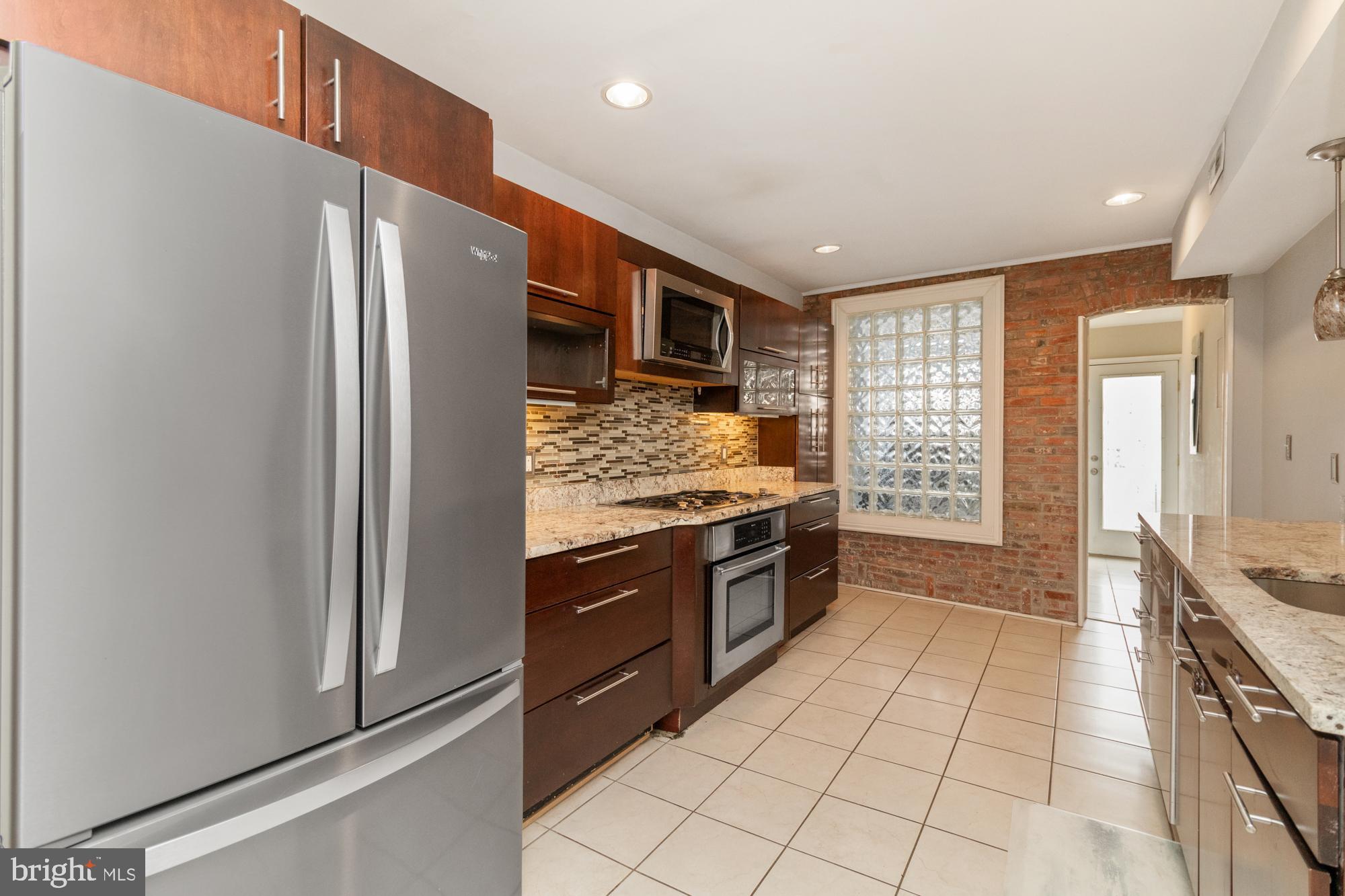 1812 Light Street Baltimore, MD 21230 - Photo 10 of 45 a kitchen with stainless steel appliances granite countertop a refrigerator and a stove
