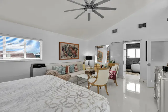 a bathroom with a sink mirror and tub
