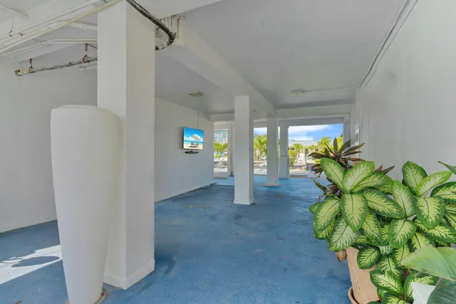 a view of a patio with table and chairs potted plants