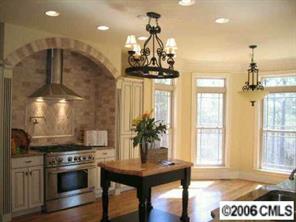 1204 Broadside Road York, SC 29745 - Photo 3 of 8 a kitchen with stainless steel appliances granite countertop a sink a stove and a wooden floors