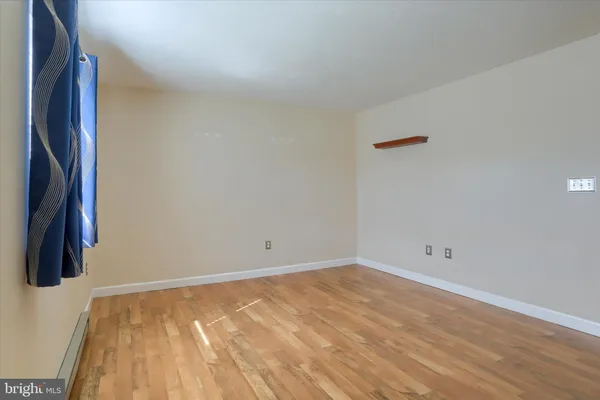 a view of a room with wooden floor and wall