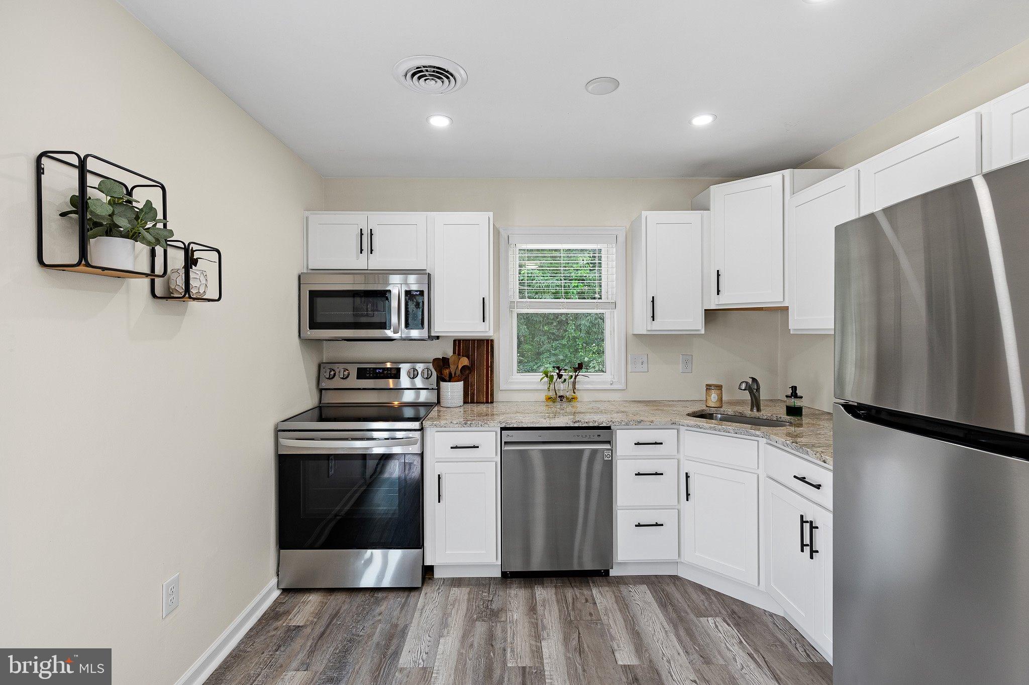 370 Big Elk Chapel Road Elkton, MD 21921 - Photo 8 of 29 a kitchen with stainless steel appliances a stove sink and refrigerator