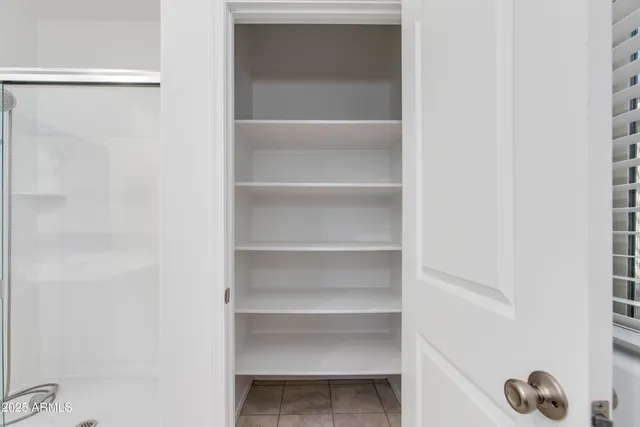 a view of walk in closet with empty racks