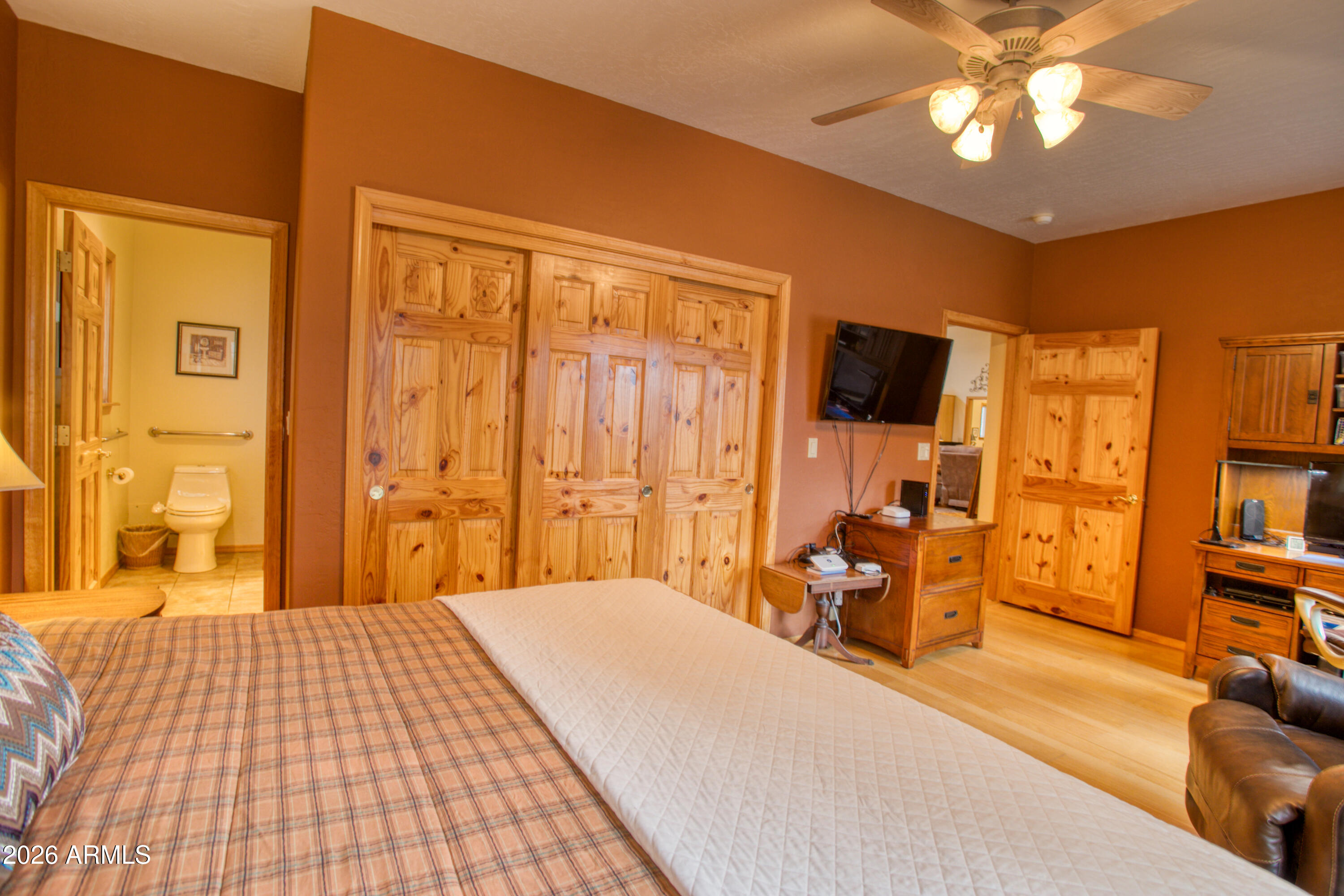 826 Pine Creek Circle Lakeside, AZ 85929 - Photo 17 of 68 a bedroom with a bed and wooden floor