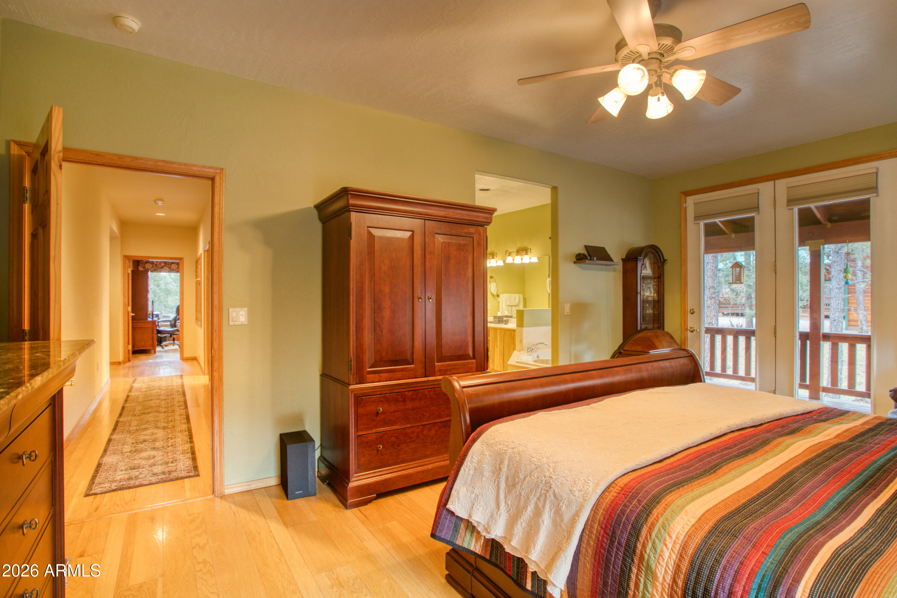 826 Pine Creek Circle Lakeside, AZ 85929 - Photo 20 of 68 a bedroom with a bed and a chandelier