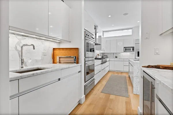 a kitchen with stainless steel appliances kitchen island granite countertop a sink and cabinets