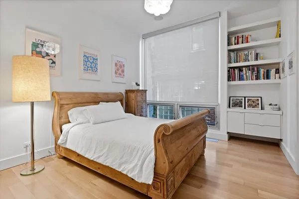 a bedroom with a bed and a potted plant