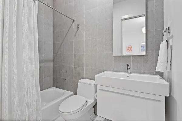 a large bathroom with a double vanity sink a mirror and a shower