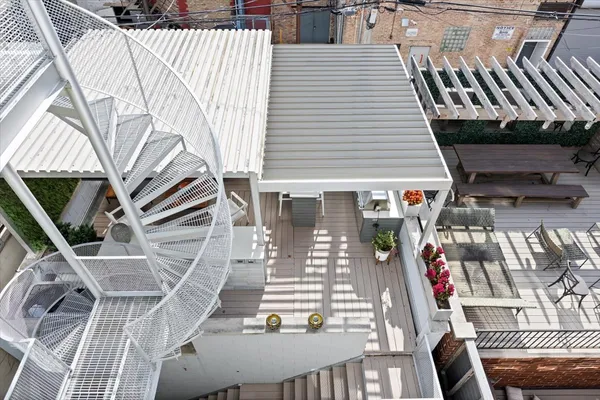 a view of a patio with couches and dining table with wooden floor