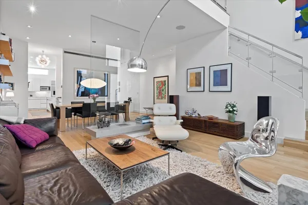 a living room with furniture and a floor to ceiling window