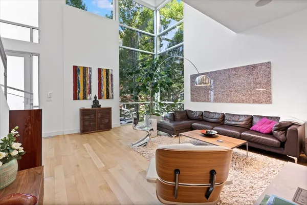 a living room with furniture and wooden floor