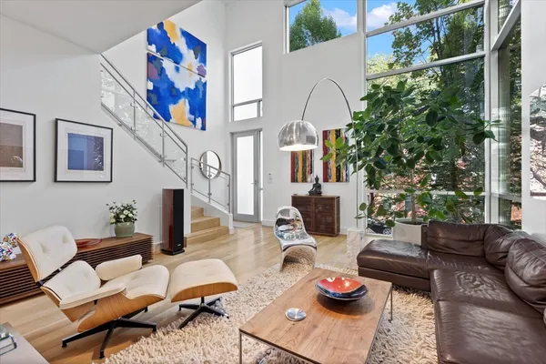 a living room with furniture potted plant and a chandelier