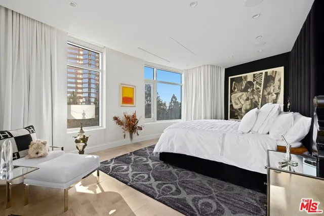 a bed room with a bed couch and a window