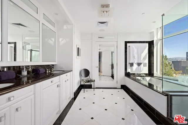 a large white kitchen with a large window