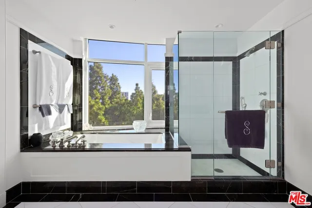 a living room with large window and a table