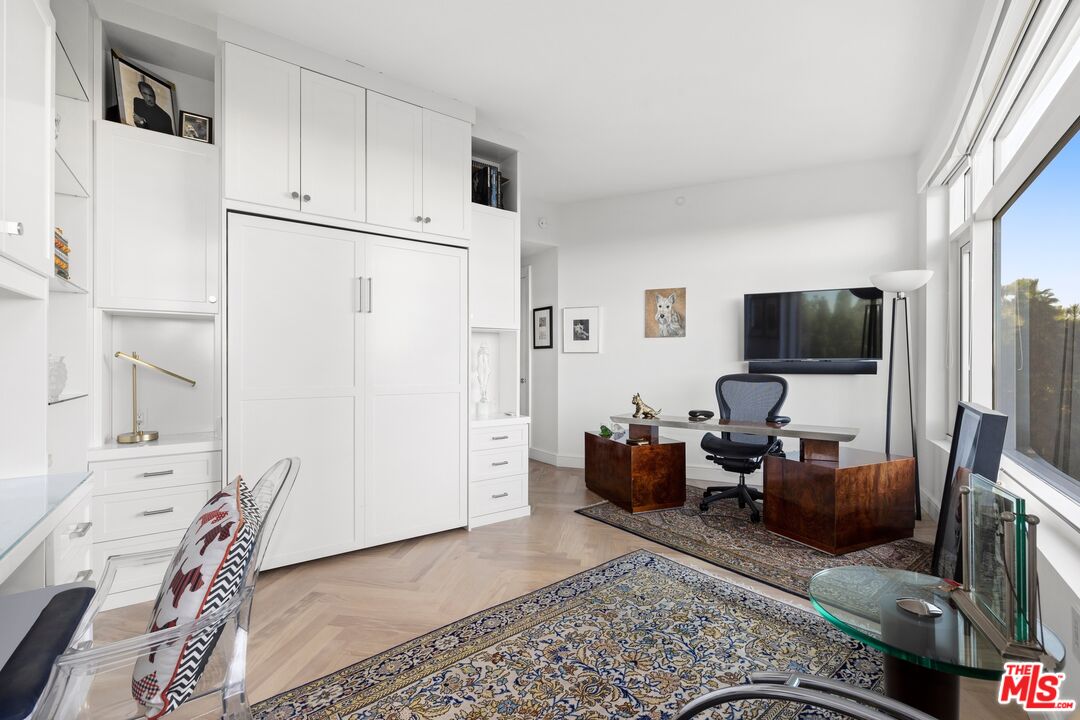 1 West Century Drive, Unit 5B Los Angeles, CA 90067 - Photo 16 of 21 a living room with furniture a flat screen tv and a refrigerator