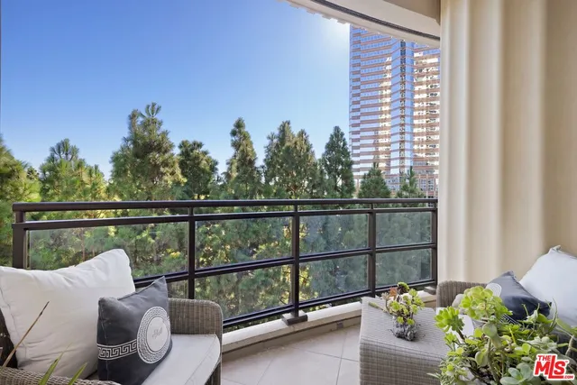 a view of a balcony with couches and wooden floor