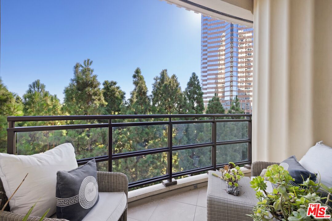 1 West Century Drive, Unit 5B Los Angeles, CA 90067 - Photo 18 of 21 a view of a balcony with couches and wooden floor