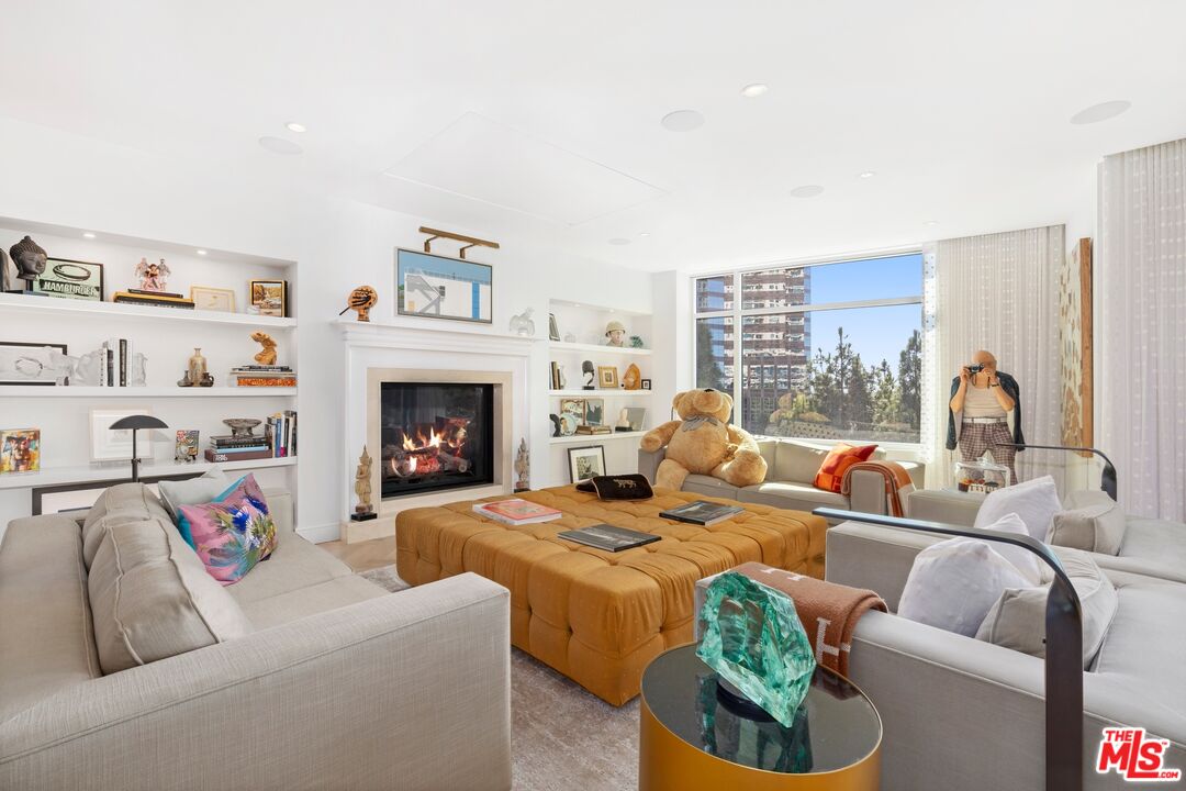 1 West Century Drive, Unit 5B Los Angeles, CA 90067 - Photo 2 of 21 a living room with furniture fireplace and a large window