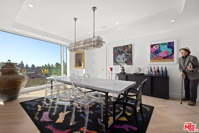 a view of a dining room with furniture and chandelier