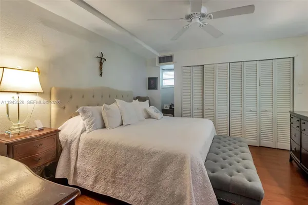 a bedroom with a bed and a lamp