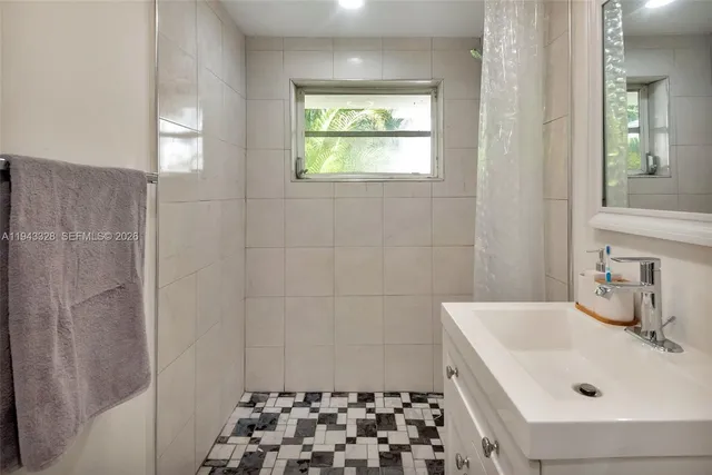 a bathroom with a sink and a shower