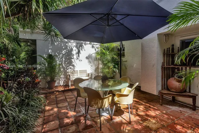 a patio with a patio table and chairs