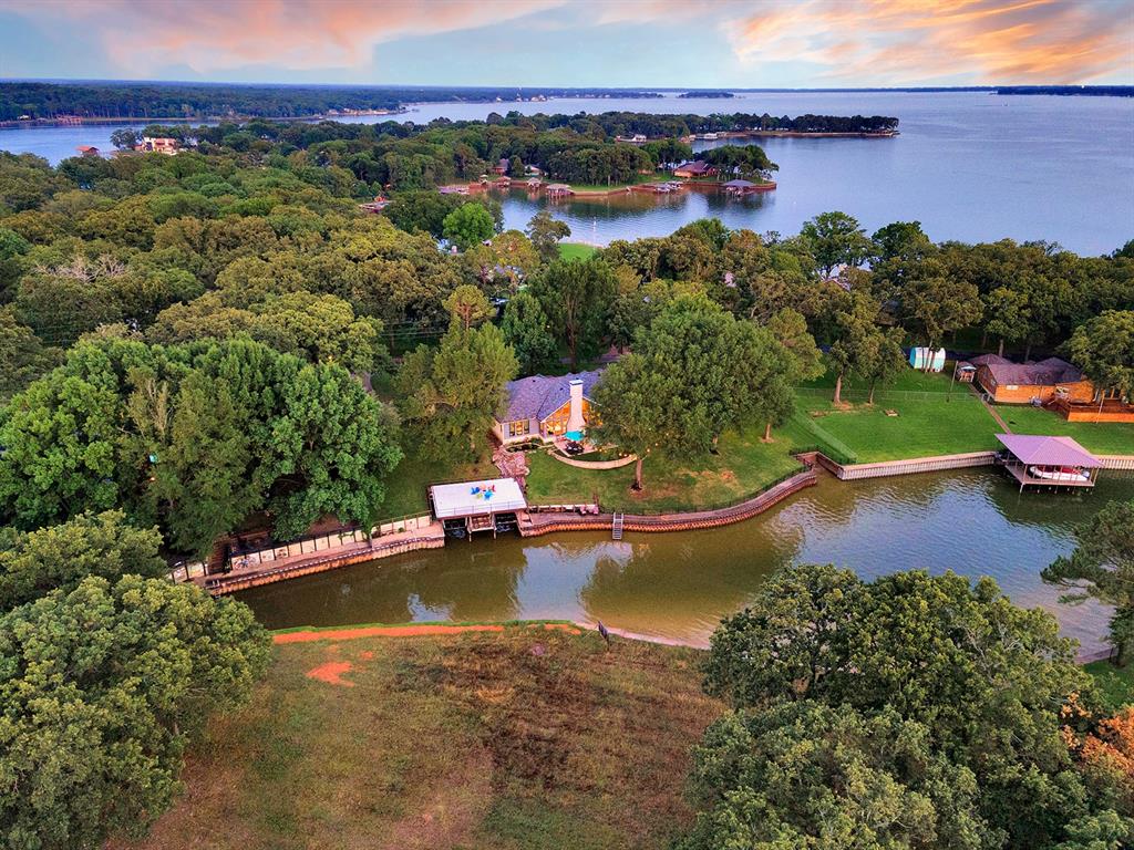 103 Glenn Road Mabank, TX 75156 - Photo 32 of 38 an aerial view of a house with a garden and lake view