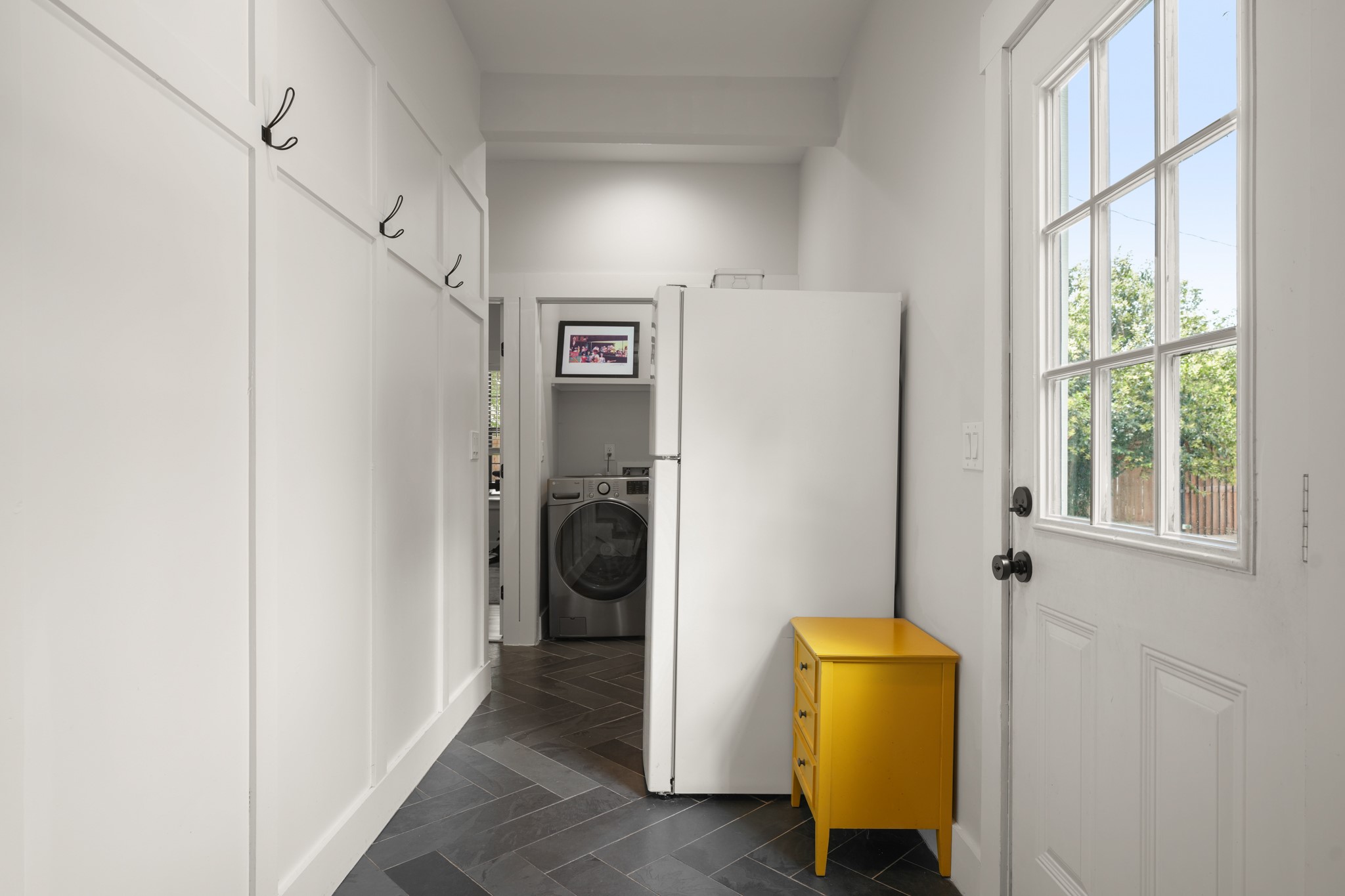 301 Old Thorndale Road Taylor, TX 76574 - Photo 24 of 29 Herringbone tile flooring defines this practical laundry room, complete with board and batten wall details.