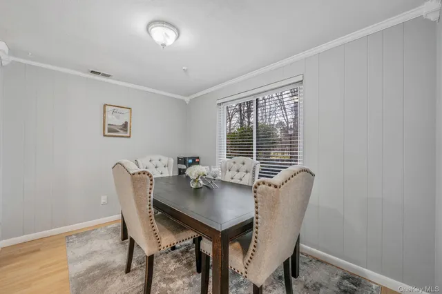 a view of a dining room with furniture and window