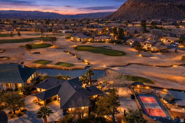 980 Cactus Circle St. George, UT 84790 - Photo 2 of 77 Aerial view at dusk of golf course view, a mountain view, and a residential view