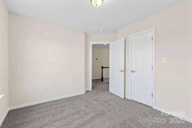 a view of an empty room with closet area