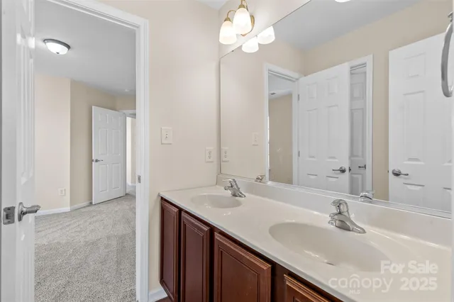 a bathroom with a sink double vanity and a mirror