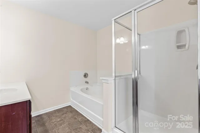 a bathroom with a bathtub and a shower