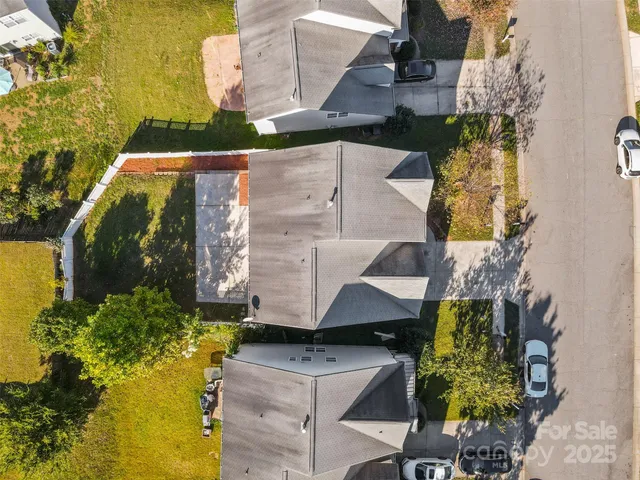 an aerial view of a house with a yard swimming pool and outdoor seating