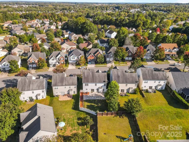 an aerial view of a houses with swimming pool