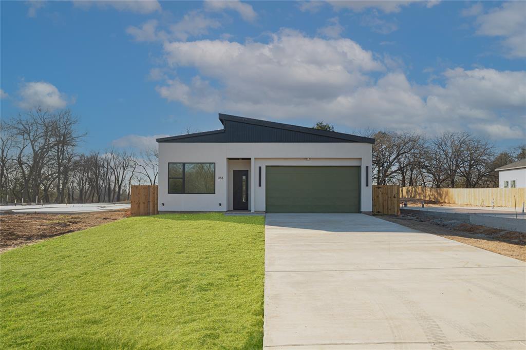 a front view of house with yard and trees