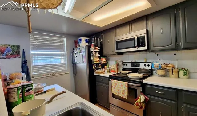 a kitchen with stainless steel appliances a stove microwave and cabinets