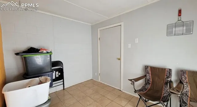 a view of a workspace with furniture and a potted plant