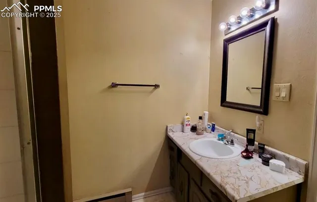 a bathroom with a sink vanity and a mirror