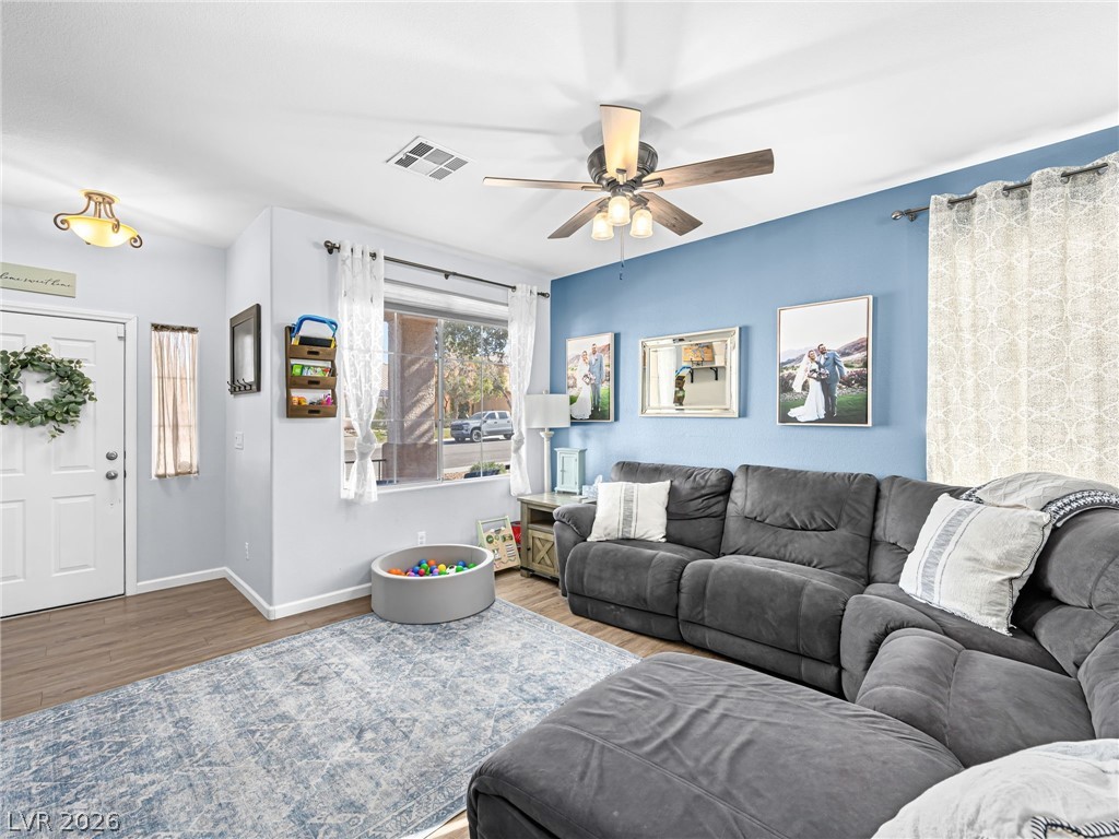 2199 Maple Shade Street Henderson, NV 89002 - Photo 2 of 75 Living area with ceiling fan, and luxury vinyl plank flooring, baseboards.