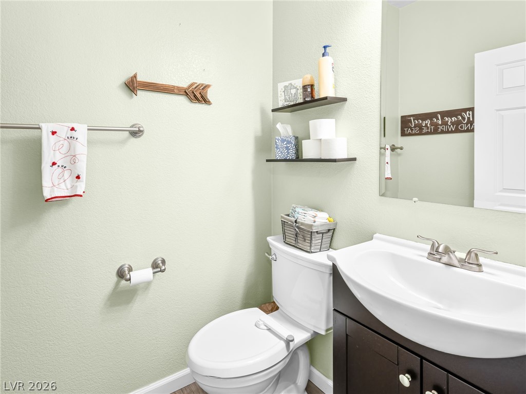 2199 Maple Shade Street Henderson, NV 89002 - Photo 23 of 75 Main-level two-piece bathroom with vanity and toilet, ideal for guests.