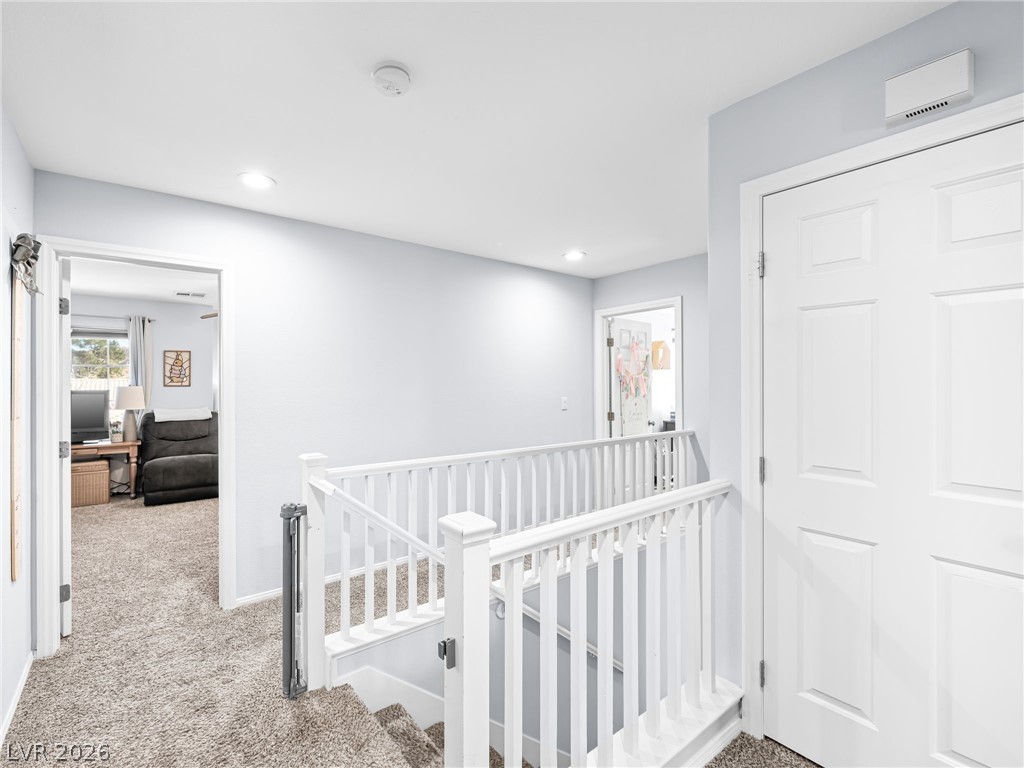 2199 Maple Shade Street Henderson, NV 89002 - Photo 24 of 75 Hallway with recessed lighting, an upstairs landing, baseboards, and carpet floors