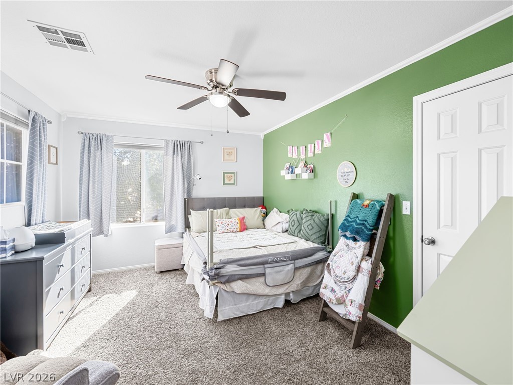 2199 Maple Shade Street Henderson, NV 89002 - Photo 29 of 75 Bedroom 3 offers carpet flooring, a ceiling fan, baseboards, and decorative molding accents.