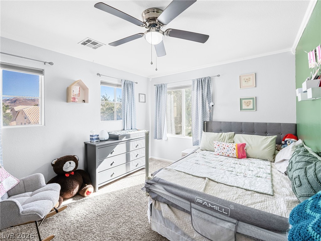 2199 Maple Shade Street Henderson, NV 89002 - Photo 30 of 75 Bedroom 3 offers carpet flooring, a ceiling fan, baseboards, and decorative molding accents.