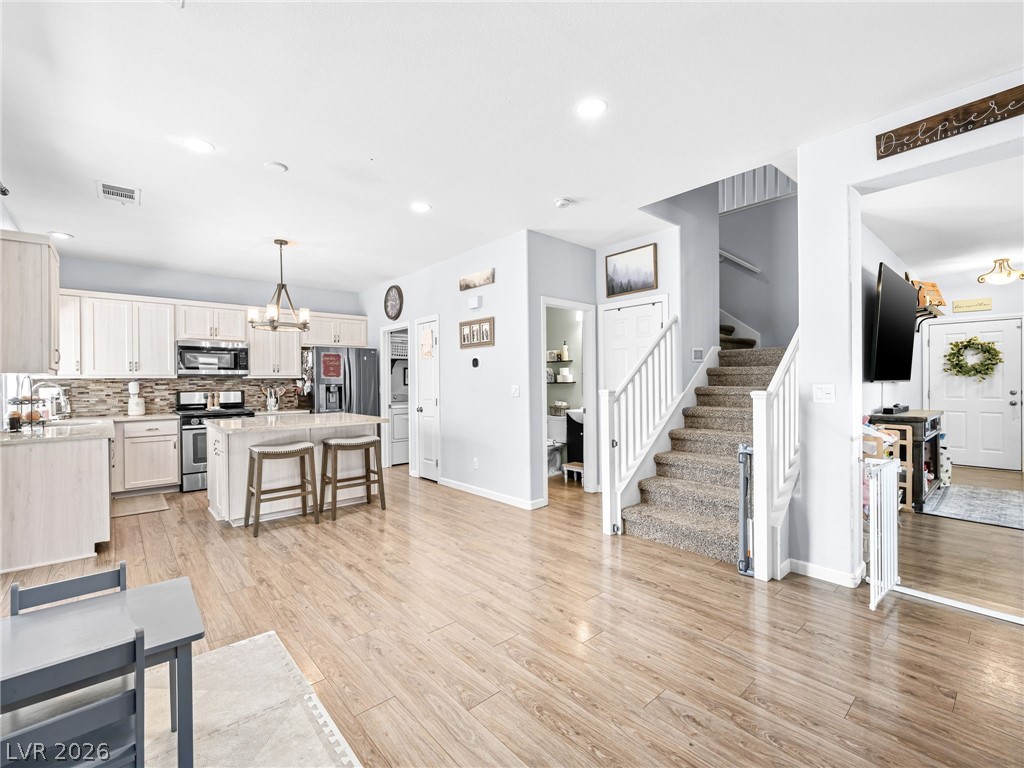 2199 Maple Shade Street Henderson, NV 89002 - Photo 6 of 75 iving area with ceiling fan, and luxury vinyl plank flooring, baseboards.