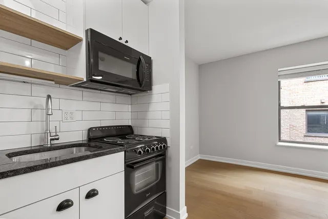 a kitchen with stainless steel appliances a stove a microwave and cabinets