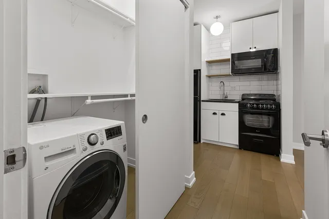a kitchen with a refrigerator and a stove top oven
