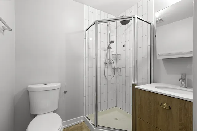 a bathroom with a toilet sink shower and mirror